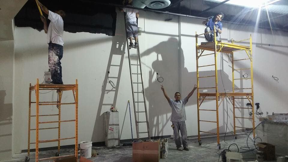 LAZO Construction crew working on a commercial build-out with scaffolding