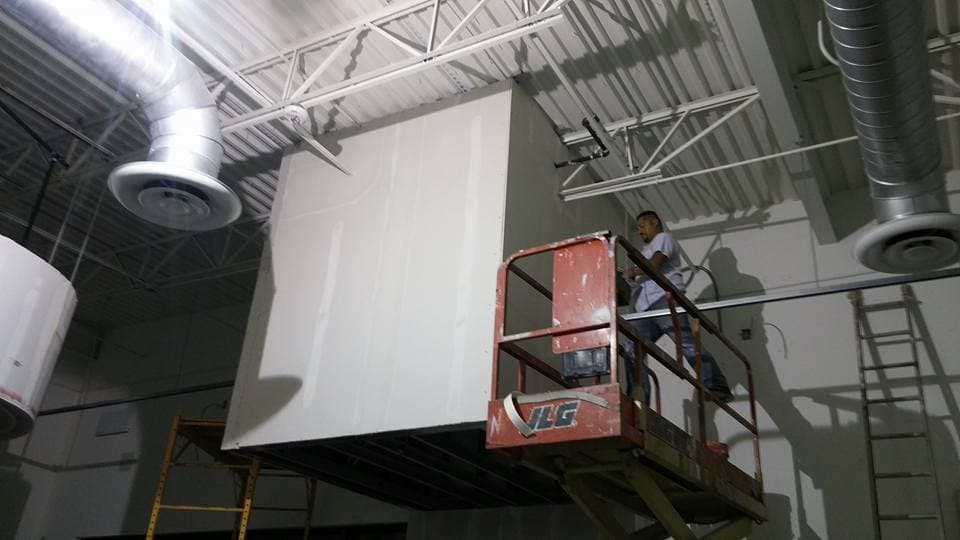 LAZO Construction commercial remodeling with scissor lift installation